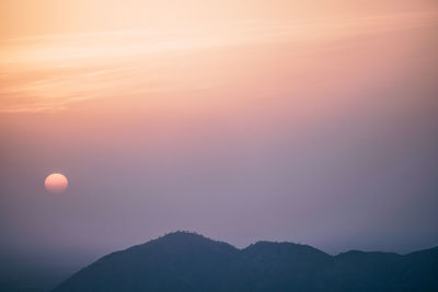 Scenic view of silhouette mountains against sky at sunset