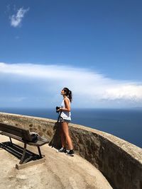 Young woman on sea against sky