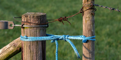 Close-up of rope tied on wooden fence