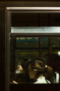 Portrait of girl looking through train window