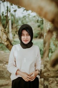 Portrait of young woman standing outdoors