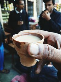 Close-up of hand holding tea cup