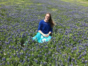 Portrait of teenage girl sitting on field