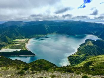 Scenic view of lake and mountains against sky