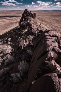 Scenic view of rock formation on landscape against sky