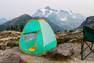 Scenic view of tent and mountains against sky