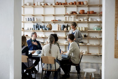 Female instructor with students in art studio