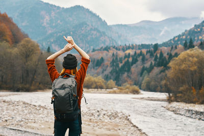 Rear view of man standing on mountain road