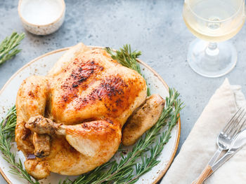 High angle view of roasted chicken in plate served on table