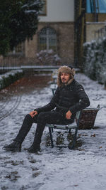 Portrait of woman sitting on snow