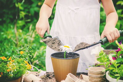 Midsection of woman gardening at farm