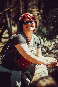 Portrait of smiling young woman sitting outdoors