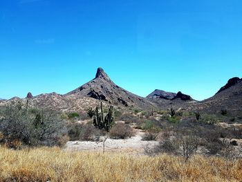 Scenic view of mountains against clear blue sky