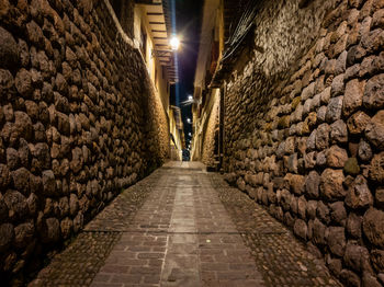 View of alley amidst wall