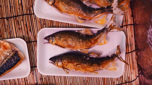 Close-up of japanese seafood in plates on bamboo place mat