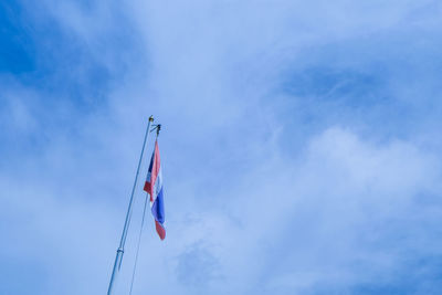 Low angle view of thai flag against cloudy sky