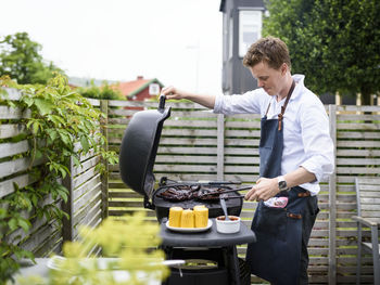 Young man doing barbecue