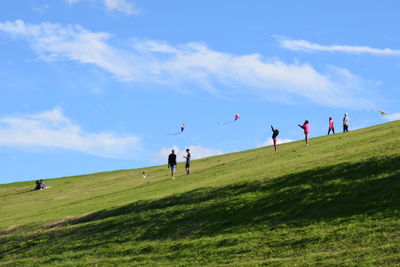 People on field against sky