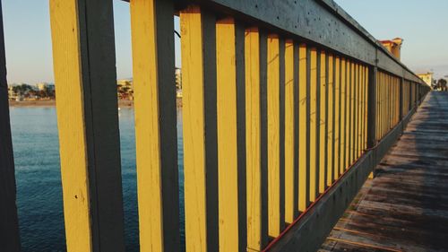 Close-up of yellow wood against sky