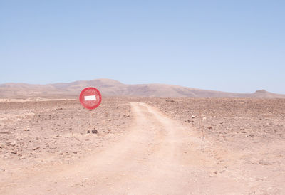 Close-up of red desert against clear sky