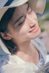 Close-up of woman wearing hat