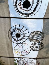 Low angle view of chandelier against sky