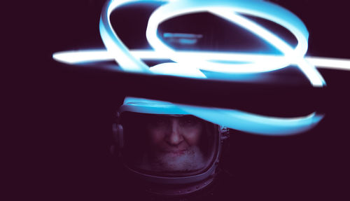 Close-up of astronaut with illuminated lighting equipment