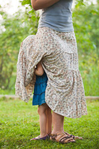 Rear view of woman standing against plants