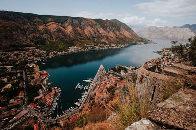 High angle view of lake and mountains against sky