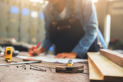 Midsection of manual worker working in carpentry workshop