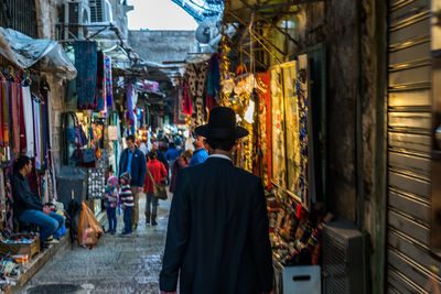 Rear view of man standing in market