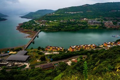 High angle view of city by dam