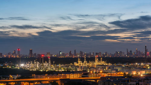 Illuminated city against sky at night