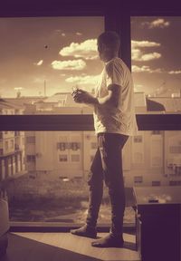 Full length of man standing against sky in city