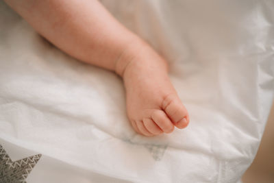 Close-up of baby feet on bed