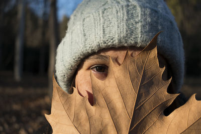 Close-up portrait of woman covering face