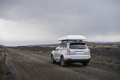 Car driving on gravel road in iceland