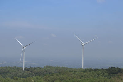 Windmill on field against sky