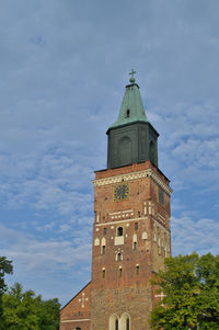 Low angle view of clock tower against sky