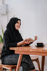 Young woman using laptop at home