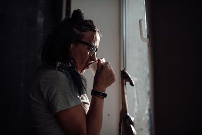 Midsection of woman holding cigarette