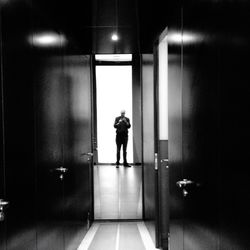 Rear view of man standing in corridor