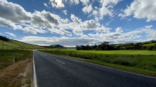Empty road along countryside landscape
