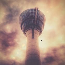 Low angle view of tower against cloudy sky