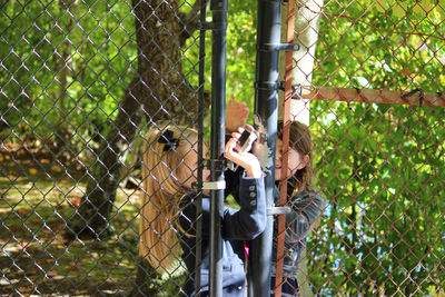 Woman in cage at zoo