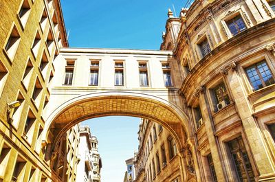 Low angle view of buildings against blue sky