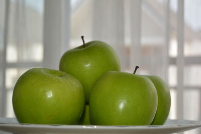 Close-up of apples in container on table