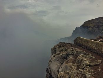 Scenic view of mountain against cloudy sky