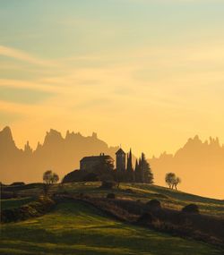 Scenic view of field against sky during sunset