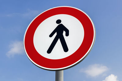 Low angle view of road sign against sky